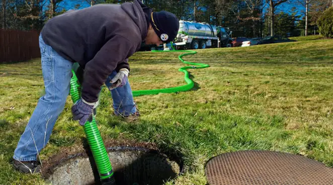 Service technician performing residential septic pumping and drainage maintenance in Tempe, AZ